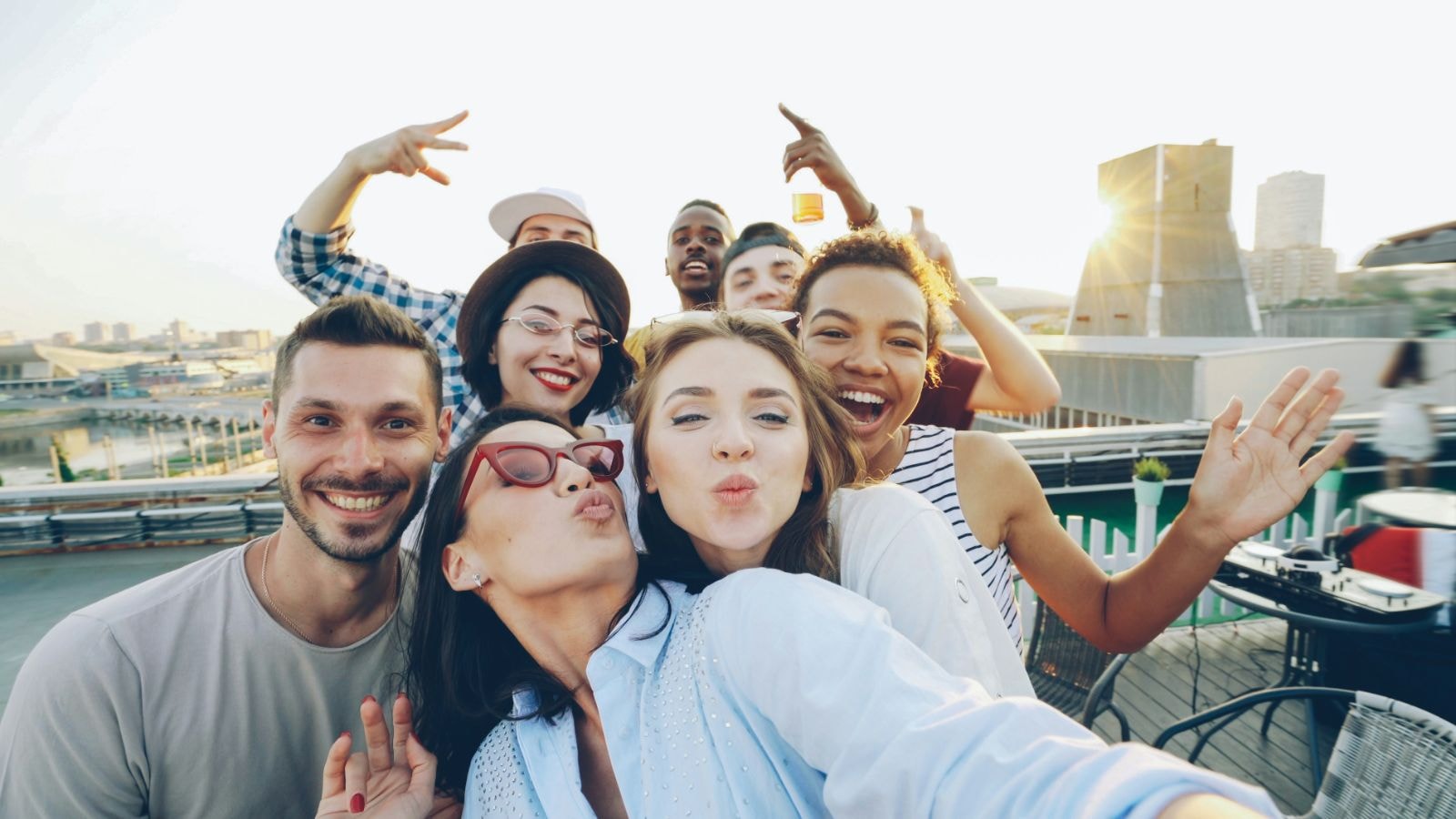 Group of friends taking a rooftop selfie, all smiling