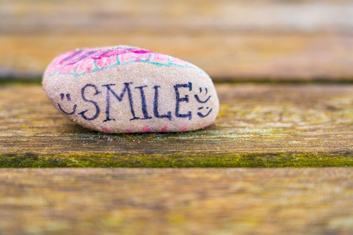 Painted stone with the word SMILE