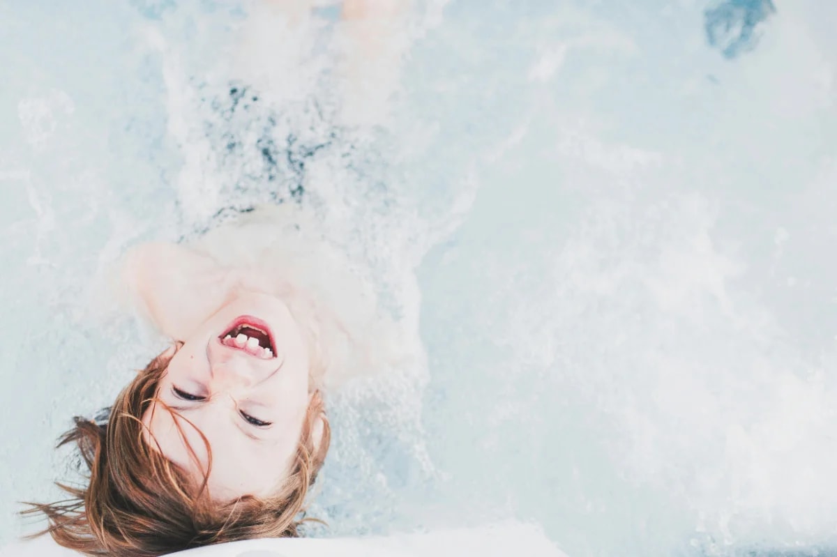 Child laughing joyfully in water